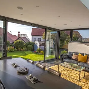 a living room filled with furniture and lots of windows