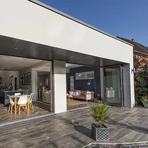 A patio with a table and chairs next to a house.